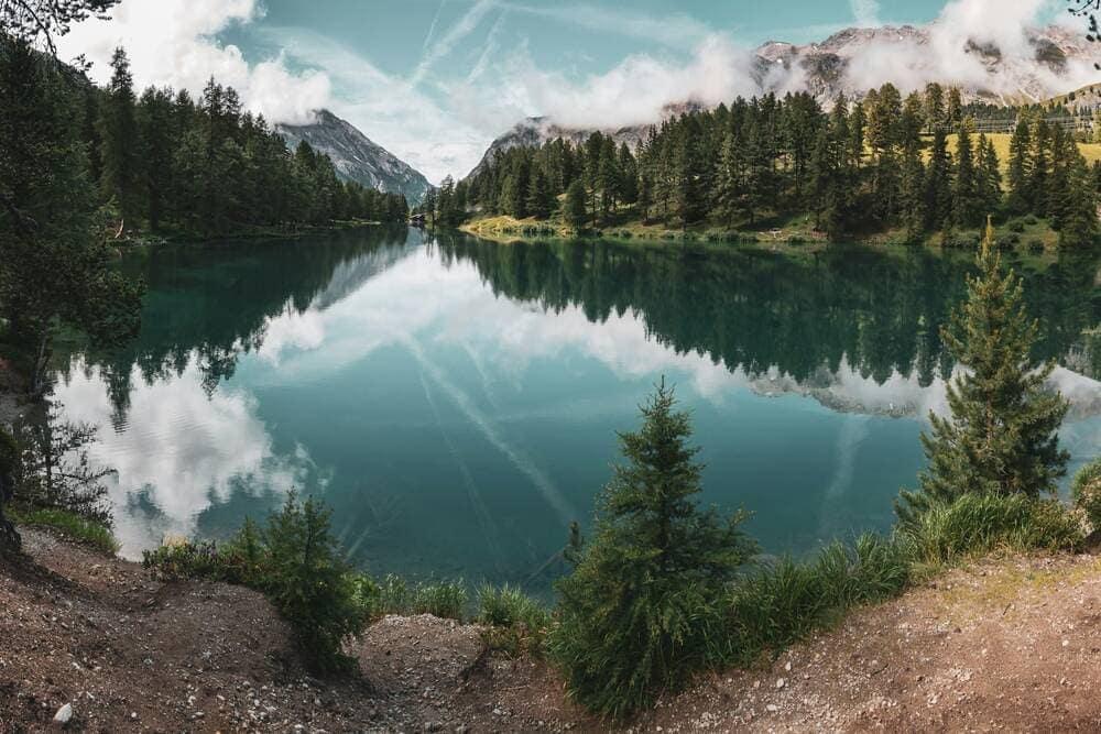 A lake with mountains in the background