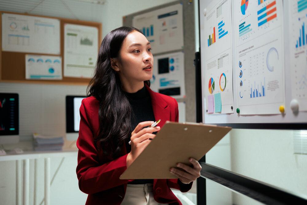 A woman surrounded by charts
