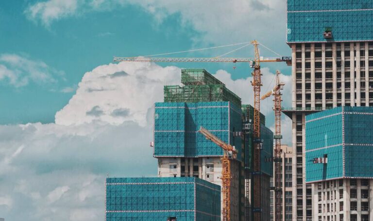 A construction development with tall building and cranes
