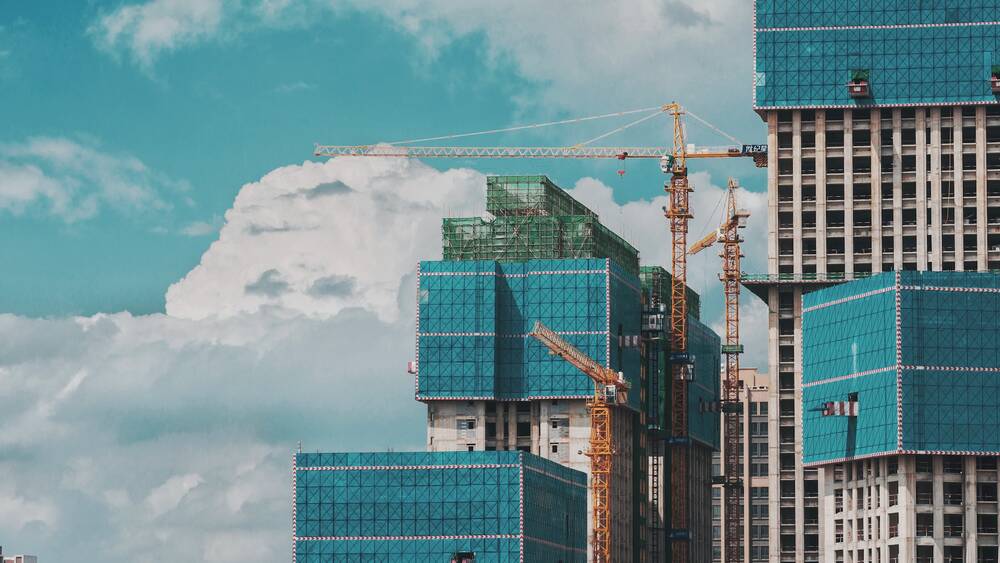A construction development with tall building and cranes