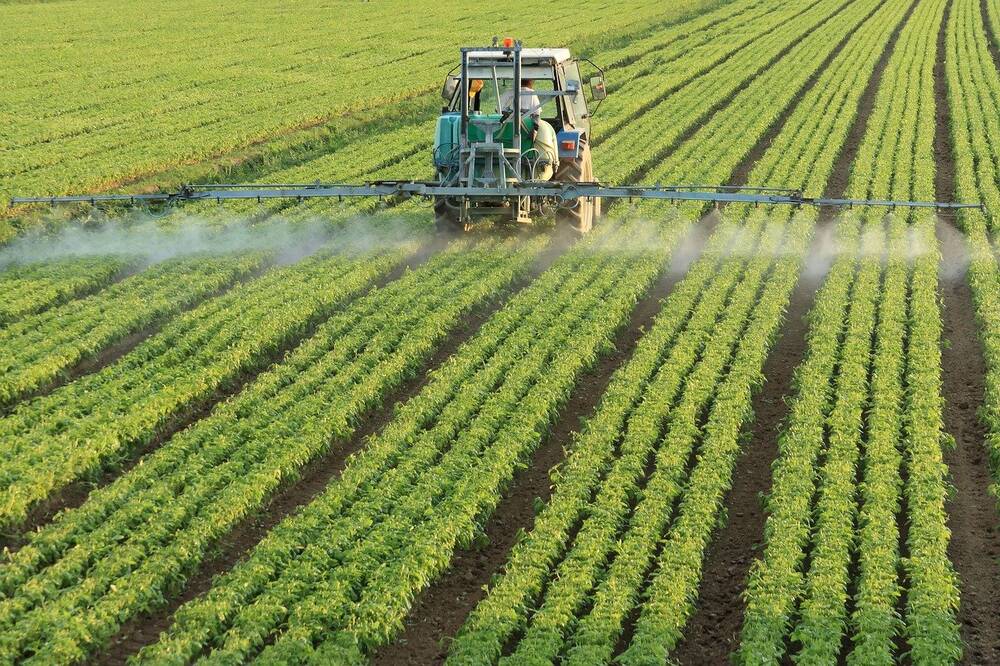 A tractor watering crops