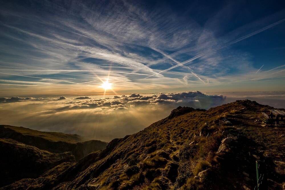 A view of the sun from a mountain