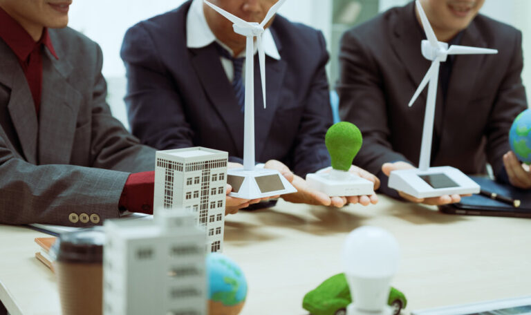 Three businessmen meeting to discuss sustainability