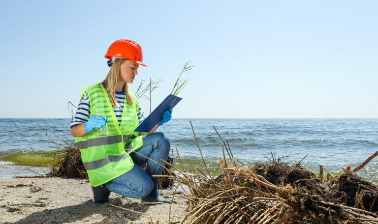A woman in a helmet examining the river water