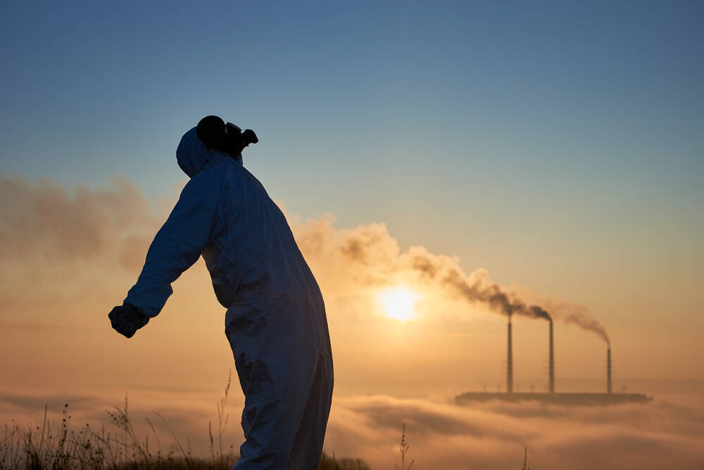 Side view of scientist in gas mask