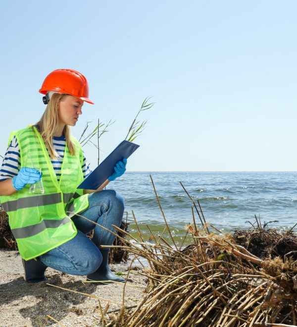 A woman in a helmet examining the river water
