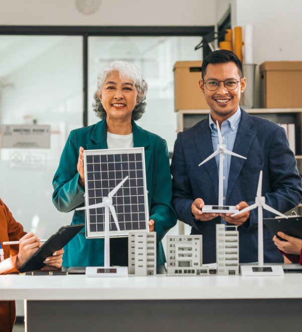 A meeting with people holding models of low carbon solutions